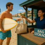 Barefoot tourist in beachwear handing a surfboard and tote bag to a smiling staff member at a sunny coastal luggage storage shack in Nice, with the turquoise Mediterranean Sea sparkling in the background. luggage storage in Nice near Promenade des Anglais