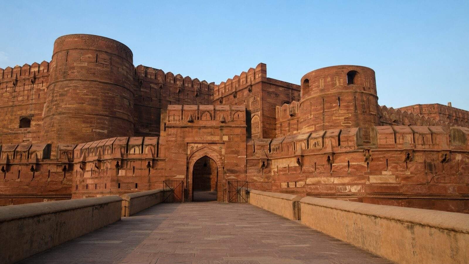 Agra Fort red sandstone walls and Mughal arches under clear daylight