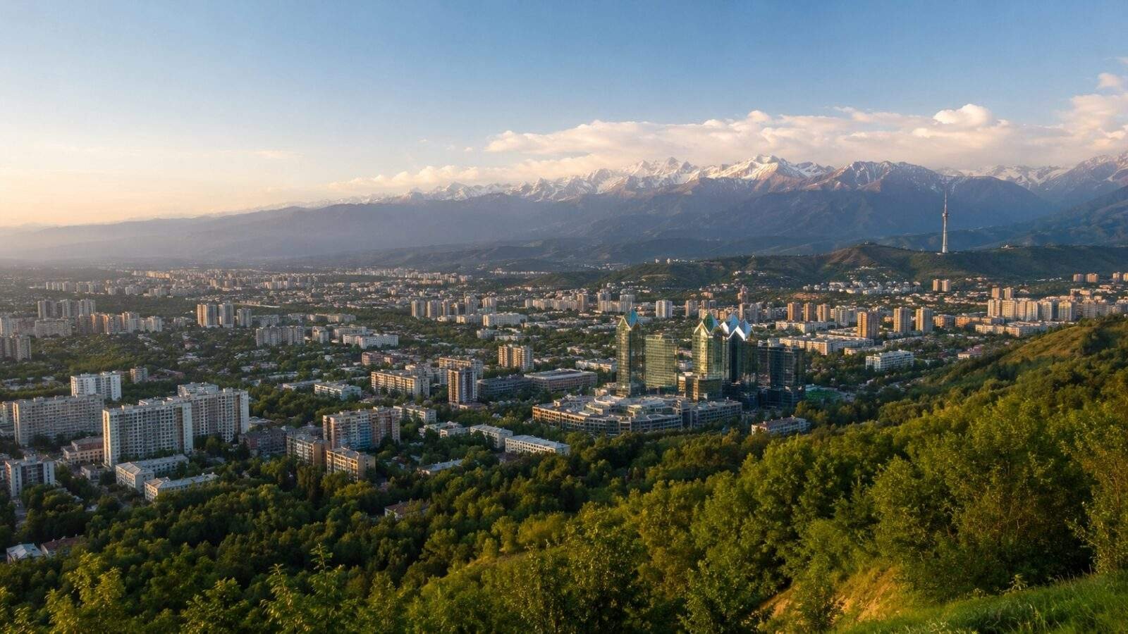 Wide view over Almaty from Kok Tobe Hill with mountains in the distance